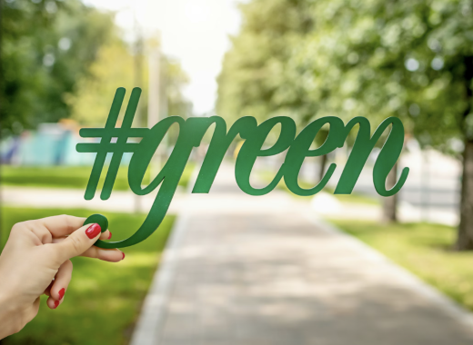 Woman Holding #green Up Against a Park Background